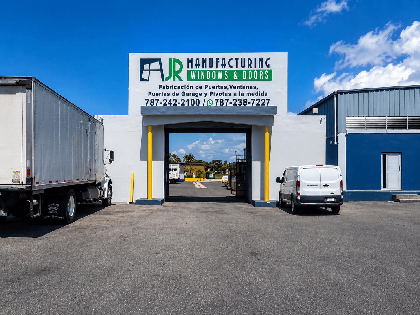 AJR Manufacturing Windows and Doors building with a large truck and van parked in front.